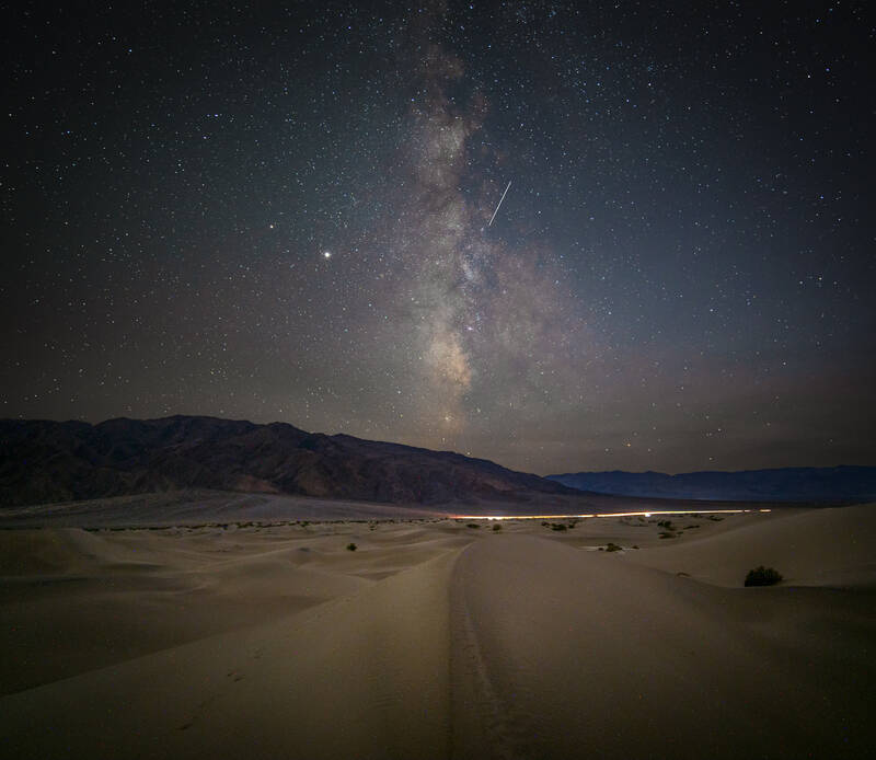 Photo of milky way over the sand dunes in Death Valley National Park. Fall.
